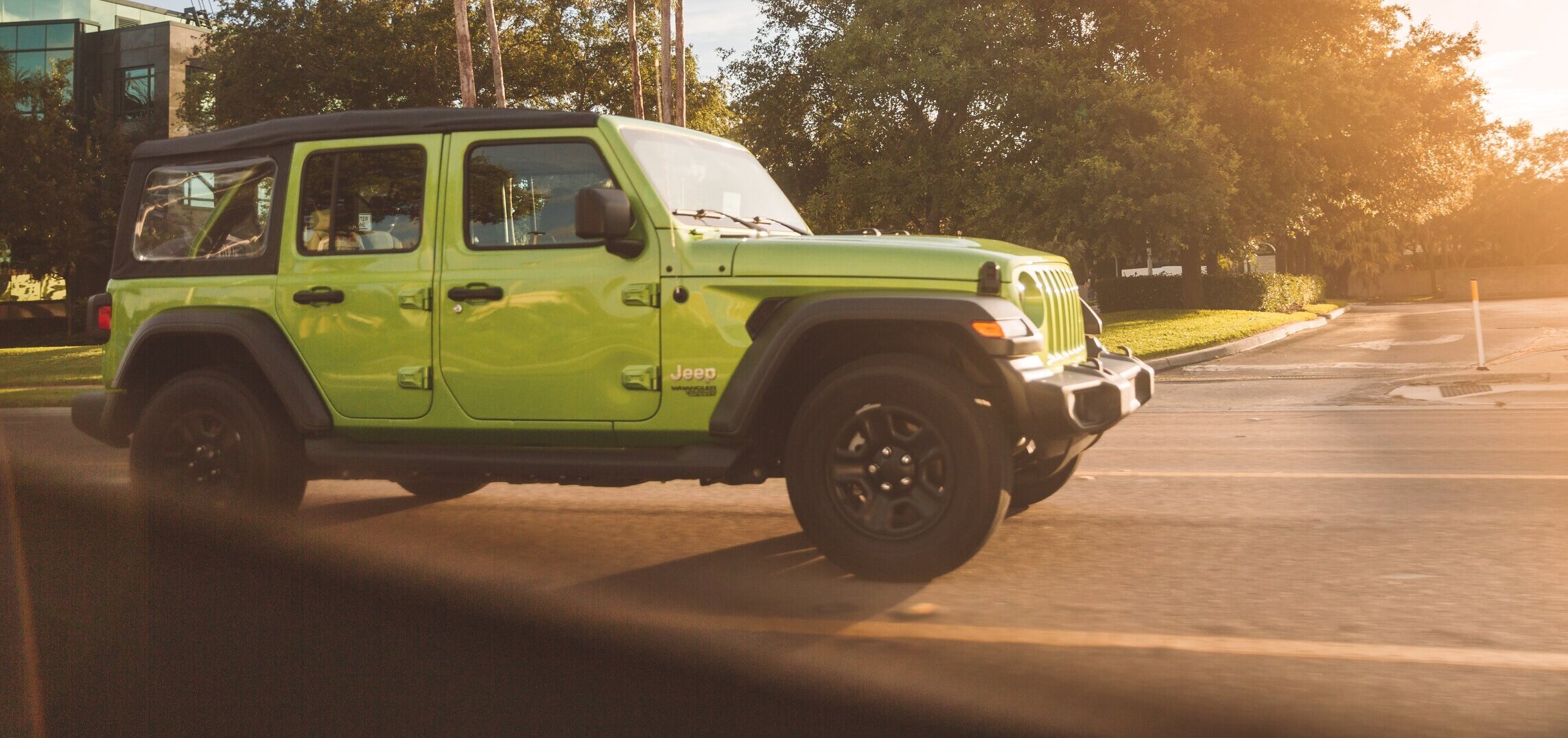 green Jeep in parking lot